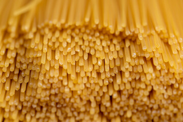 made from durum wheat and water long thin yellow spaghetti, long spaghetti pasta with a round cross-section made from quality grains