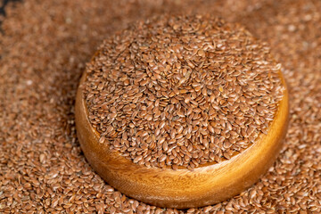 flax seeds poured into a wooden bowl, a bowl completely filled with flax seeds, which can be used both for nutrition and for obtaining a new crop