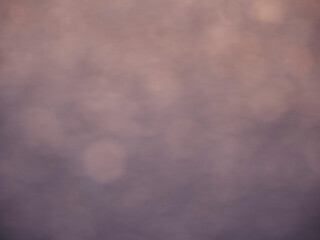 A blurry image of a purple background with a few dots scattered around. The image has a dreamy, ethereal quality to it