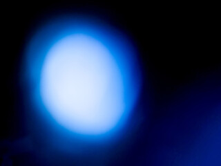 Blue color light leaks on a dark background. Colorful burst of light for design or special effects.