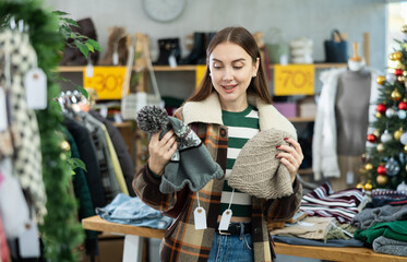 Girl at trading floor pick out and buying ladys warm hat. Off line clothing store from retailer. Style and fashion look, modern trends. Designer clothing store, vintage fashion, limited edition