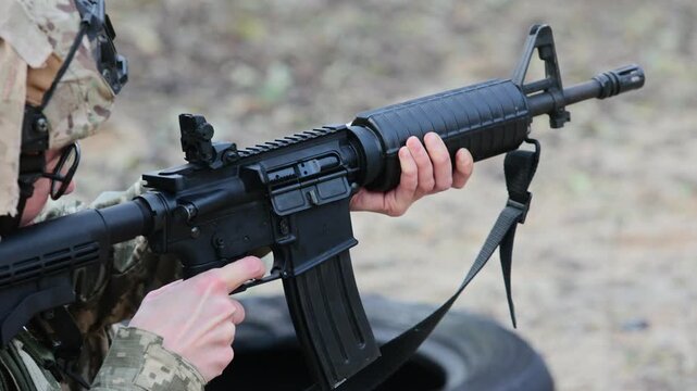 Close-up of a soldier firing an assault rifle. Concept for modern warfare, combat training, and disciplined focus.