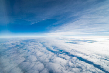 View from an airplane of clouds and a beautiful blue sky