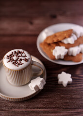 cozy cappuccino topped with chocolate sprinkles in a ceramic cup beside a plate of cookies and sugar pieces on a rustic wooden table setting, capturing a warm, inviting atmosphere, aesthetic