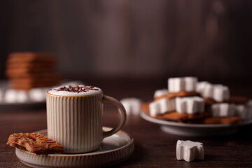 cozy autumn scene featuring a mug of hot chocolate with marshmallows and cookies on a wooden table with a warm, inviting atmosphere and soft lighting, ambiance, luxurious, classic, brownie, serene