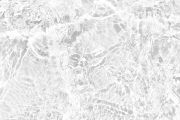 Naklejka premium White water with ripples on the surface. Defocus blurred transparent white colored clear calm water surface texture with splashes and bubbles. Water waves with shining pattern texture background.