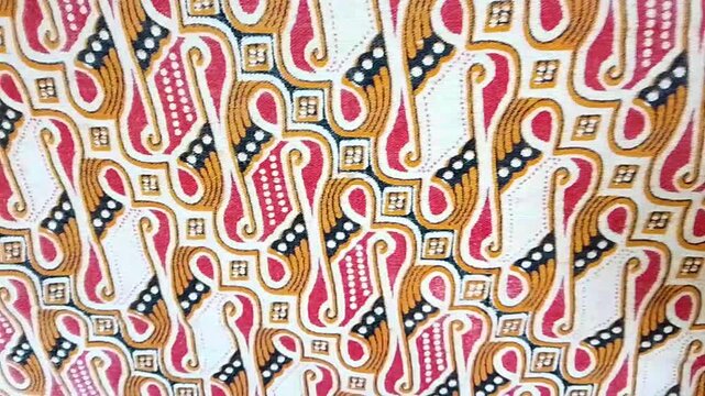 Video The parang batik motif appears abstract, with repeating patterns resembling geometric shapes. It's a traditional Indonesian motif