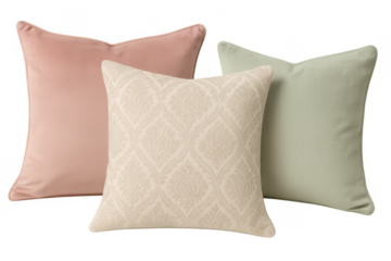 Three decorative pillows in muted colors on transparent background