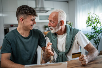Grandfather and grandson enjoying online shopping experience together