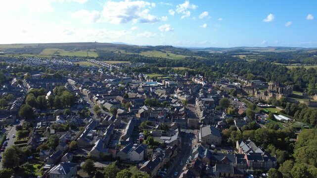 Scenic high aerial view of the town of Alnwick in Northumberland showing the town streets and buildings surrounded by countryside
