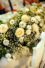 Elegant floral decorations on dining tables prepared for celebration, beautiful flower arrangements creating festive and romantic atmosphere