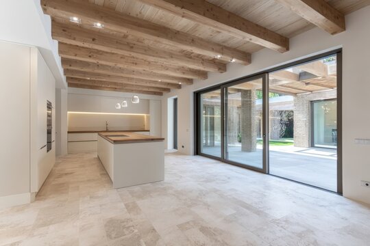 Bright Open Concept Kitchen Interior Featuring Wooden Beams, Large Sliding Doors, and Neutral Tones