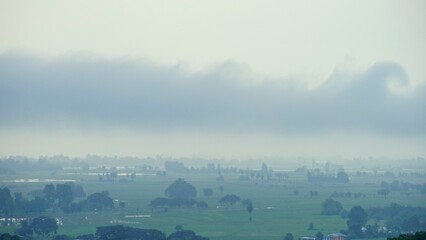 Dramatic foggy morning in the countryside of Thailkand. Landscape of rainy