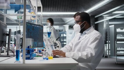 Researcher wearing medical mask in sterile laboratory using computer for DNA data analysis. African amerian man wearing protective face mask using bioinformatics genomics software on PC, camera A