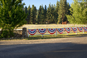 Red, white, and blue patriotic bunting with white stars on the blue section, shaped in semicircles...