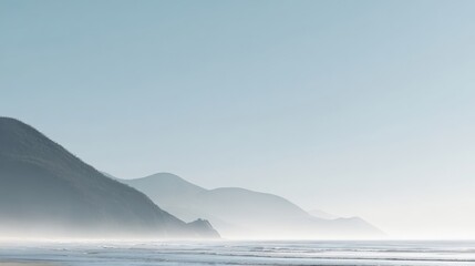 Fototapeta premium Serene Coastal Landscape with Misty Mountains and Calm Ocean Scenery on a Sunny Day