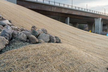 Roadside slope erosion control with single net  blanket installed on ground to protect from weeds and water erosion