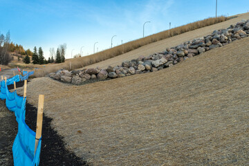 Roadside slope erosion control with single net  blanket installed on ground to protect from weeds and water erosion