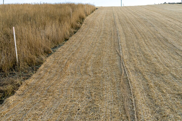 Roadside slope erosion control with single net  blanket installed on ground to protect from weeds and water erosion