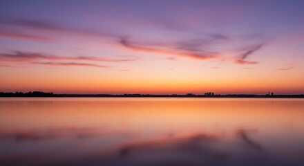 Vibrant sunset glow blankets the tranquil lake its smooth surface perfectly reflecting the dramatic orange and purple sky. AI Generated