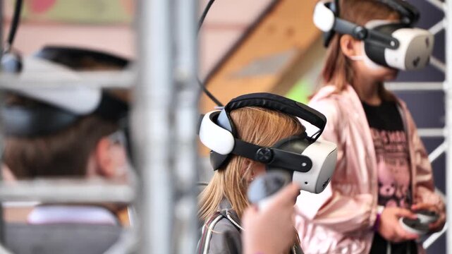 Girls experiencing virtual reality entertainment with VR headsets