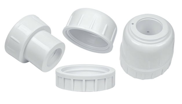 White plastic fitting parts scattered on a dark gray surface