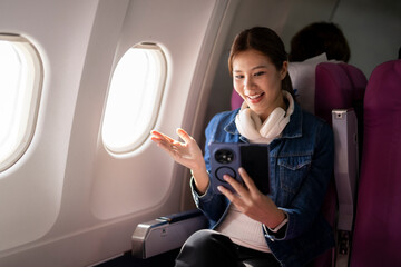 Woman enjoying video call during airplane travel