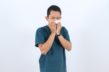 Sick man blowing nose with tissue. Cold, flu or allergy symptom.