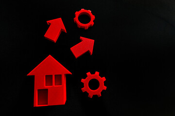 calculates finances for buying a new house and car, surrounded by documents, calculator, and model...