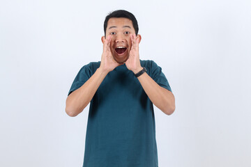Surprised Asian man shouting a loud announcement or great news.