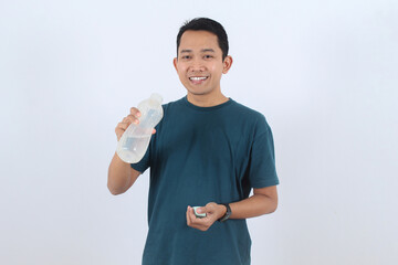 Smiling Asian man holding reusable water bottle for healthy hydration