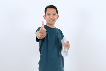 Happy Asian man with water bottle gives thumbs up for hydration