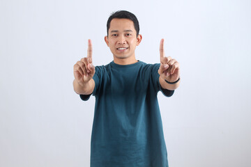 Happy Asian man pointing up with index fingers, success gesture.