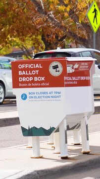 Vertical video of an official ballot drop box marked with &ldquo;Official Ballot Drop Box&rdquo; and &ldquo;Buz&oacute;n de Boleta Oficial,&rdquo; established as a convenient option for voters who drive by in cars to submit ballots