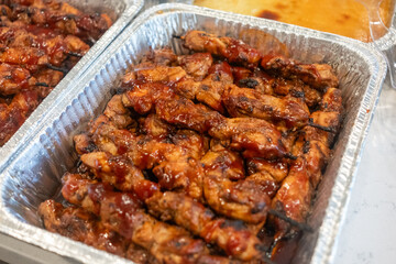 Savory Filipino barbecue chicken wings prepared for a festive gathering in a local neighborhood cookout