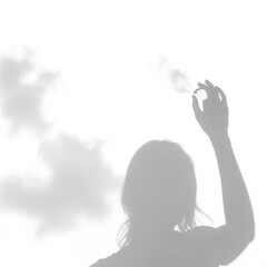 Silhouette of a woman raising her hand against a bright white background