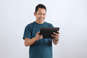 Smiling Asian man using digital tablet isolated on white background