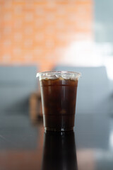 Close up of Americano iced coffee or black coffee in glass on wood table