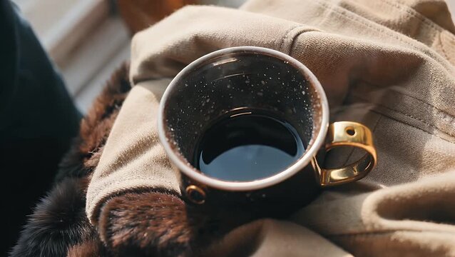 Perspective Photograph of a Steaming Hot Coffee Cup Placed Cozily on a Soft Knitted