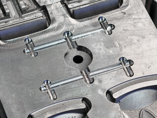 Close view of metal molds used in plastic injection molding process for manufacturing components