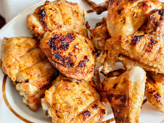 Grilled chicken wings served on a plate with a golden-brown texture and appetizing appearance during a summer gathering