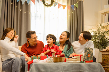 family, christmas, happy family, families, Happy Asian family celebrating Christmas at home, surrounded by gifts and decorations, enjoying laughter, love, and joyful holiday moments together.