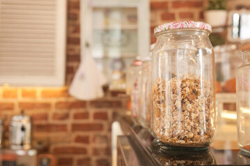 Various jars filled with dry tea leaf .