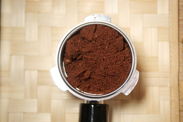 Freshly ground coffee ready for brewing in a portafilter