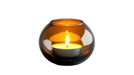 A lit tea light candle inside a round brown glass holder isolated on a black background in a studio shot