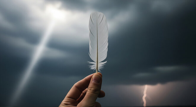 A hand holds a delicate white feather against a stormy sky with lightning and sun rays, a concept for hope, inspiration, and resilience in adversity