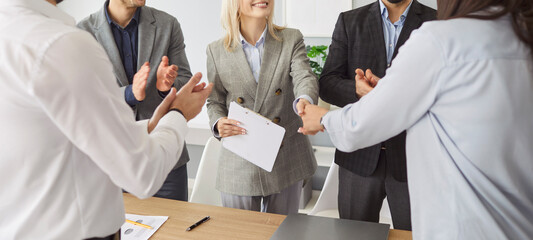 Group of office people shaking hands, concluding deal or acknowledging agreement, receiving...