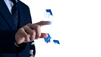 Businessperson's finger touching a glowing, stylized dollar sign, overlaid on a black background