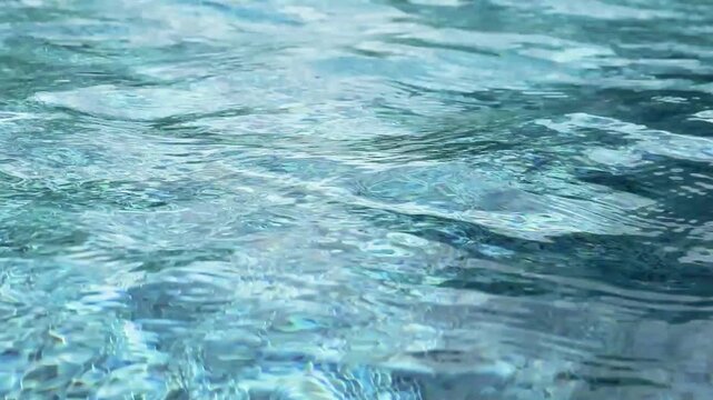 Swimming pool with blue crystal clear water surface and ripple wave background
