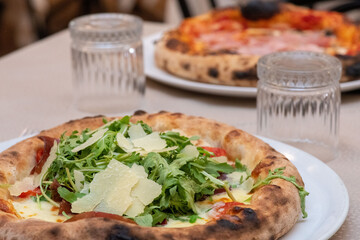 Freshly baked pizza coming out of the oven in a traditional Italian pizzeria setting
